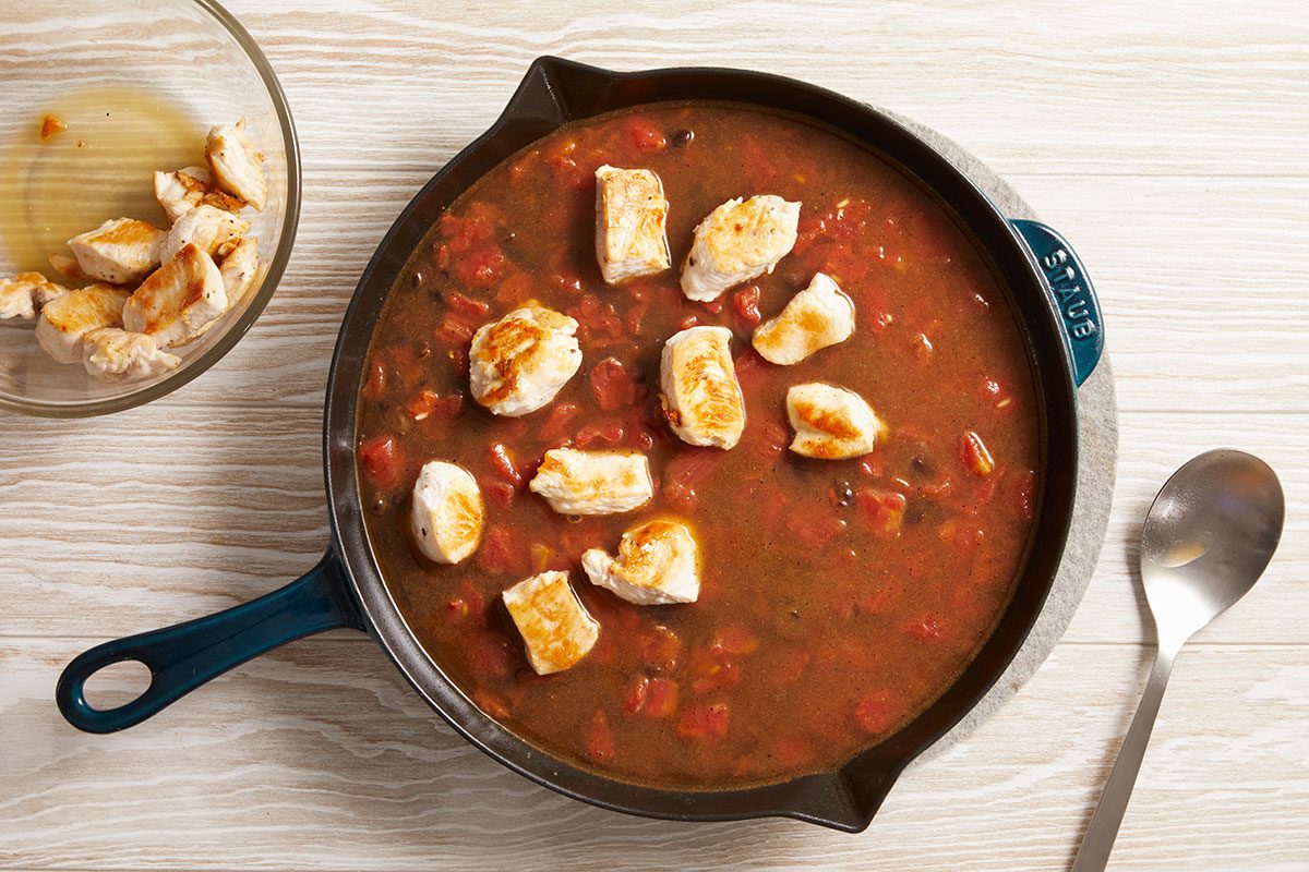 Overhead shot of simmering sauce with chicken added back in.