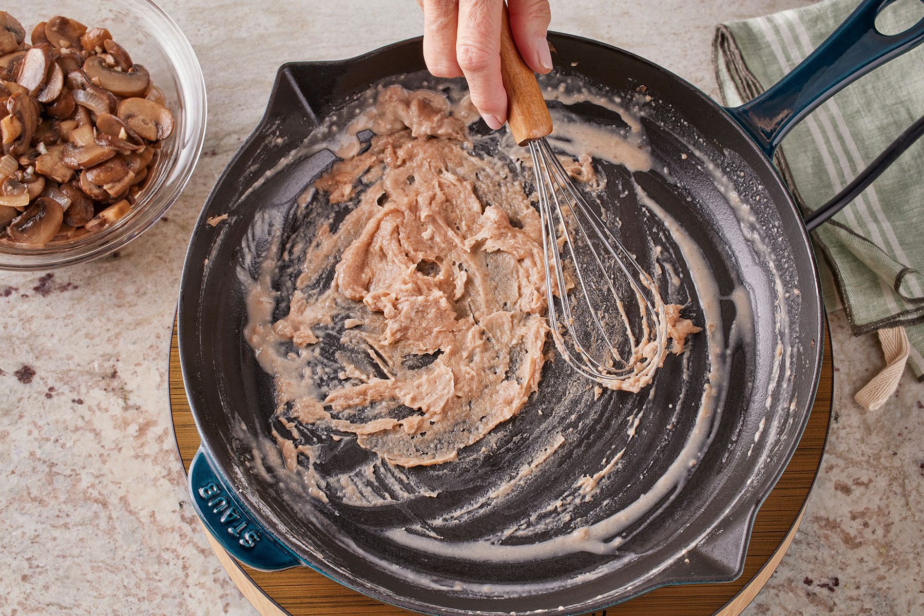 Stirring flour in mushroom mixture remains and butter in a large skillet with a help of a whisk.
