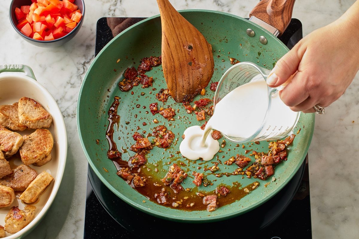 heavy cream being added to pan